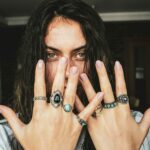 woman showing her rings on her fingers