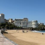 Scenic view of the beach and buildings in Biarritz, France, under a clear blue sky.