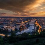 Beautiful sunset view of Rouen, France with illuminated cityscape and Seine River.